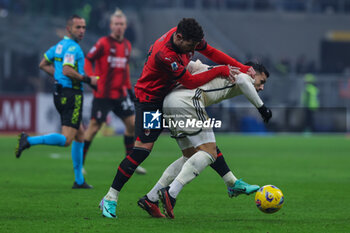 2024-01-14 - Theo Hernandez of AC Milan competes for the ball with Leandro Paredes of AS Roma during Serie A 2023/24 football match between AC Milan and AS Roma at San Siro Stadium, Milan, Italy on January 14, 2024 - AC MILAN VS AS ROMA - ITALIAN SERIE A - SOCCER