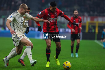 2024-01-14 - Tijjani Reijnders of AC Milan competes for the ball with Rasmus Kristensen of AS Roma during Serie A 2023/24 football match between AC Milan and AS Roma at San Siro Stadium, Milan, Italy on January 14, 2024 - AC MILAN VS AS ROMA - ITALIAN SERIE A - SOCCER