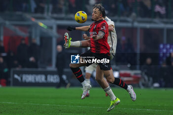 2024-01-14 - Noah Okafor of AC Milan competes for the ball with Dean Huijsen of AS Roma during Serie A 2023/24 football match between AC Milan and AS Roma at San Siro Stadium, Milan, Italy on January 14, 2024 - AC MILAN VS AS ROMA - ITALIAN SERIE A - SOCCER