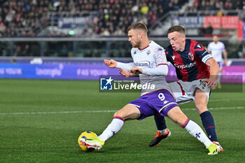 2024-02-14 - ACF Fiorentina's forward Lucas Beltran against Bologna FC's midfielder Lewis Ferguson - BOLOGNA FC VS ACF FIORENTINA - ITALIAN SERIE A - SOCCER