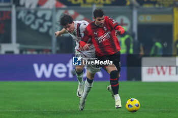 2024-01-27 - Theo Hernandez of AC Milan competes for the ball with Giovanni Fabbian of Bologna FC during Serie A 2023/24 football match between AC Milan and Bologna FC at San Siro Stadium, Milan, Italy on January 27, 2024 - AC MILAN VS BOLOGNA FC - ITALIAN SERIE A - SOCCER