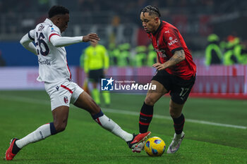 2024-01-27 - Noah Okafor of AC Milan competes for the ball with Jhon Lucumi of Bologna FC during Serie A 2023/24 football match between AC Milan and Bologna FC at San Siro Stadium, Milan, Italy on January 27, 2024 - AC MILAN VS BOLOGNA FC - ITALIAN SERIE A - SOCCER