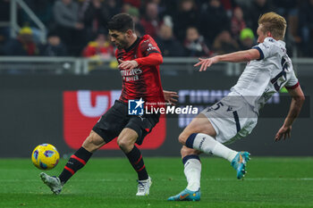 2024-01-27 - Christian Pulisic of AC Milan seen in action with Victor Kristiansen of Bologna FC during Serie A 2023/24 football match between AC Milan and Bologna FC at San Siro Stadium, Milan, Italy on January 27, 2024 - AC MILAN VS BOLOGNA FC - ITALIAN SERIE A - SOCCER