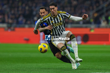 2024-02-04 - Dusan Vlahovic of Juventus FC competes for the ball with Hakan Calhanoglu of FC Internazionale during Serie A 2023/24 football match between FC Internazionale and Juventus FC at Giuseppe Meazza Stadium, Milan, Italy on February 04, 2024 - INTER - FC INTERNAZIONALE VS JUVENTUS FC - ITALIAN SERIE A - SOCCER