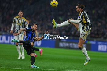 2024-02-04 - Adrien Rabiot of Juventus FC competes for the ball with Hakan Calhanoglu of FC Internazionale during Serie A 2023/24 football match between FC Internazionale and Juventus FC at Giuseppe Meazza Stadium, Milan, Italy on February 04, 2024 - INTER - FC INTERNAZIONALE VS JUVENTUS FC - ITALIAN SERIE A - SOCCER