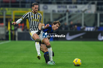 2024-02-04 - Adrien Rabiot of Juventus FC competes for the ball with Nicolo Barella of FC Internazionale during Serie A 2023/24 football match between FC Internazionale and Juventus FC at Giuseppe Meazza Stadium, Milan, Italy on February 04, 2024 - INTER - FC INTERNAZIONALE VS JUVENTUS FC - ITALIAN SERIE A - SOCCER