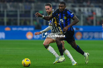 2024-02-04 - Marcus Thuram of FC Internazionale competes for the ball with Adrien Rabiot of Juventus FC during Serie A 2023/24 football match between FC Internazionale and Juventus FC at Giuseppe Meazza Stadium, Milan, Italy on February 04, 2024 - INTER - FC INTERNAZIONALE VS JUVENTUS FC - ITALIAN SERIE A - SOCCER