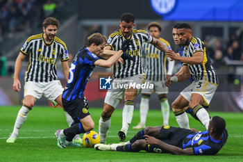 2024-02-04 - Nicolo Barella of FC Internazionale and Marcus Thuram of FC Internazionale compete for the ball with Gleison Bremer of Juventus FC, Luiz da Silva Danilo of Juventus FC and Manuel Locatelli of Juventus FC during Serie A 2023/24 football match between FC Internazionale and Juventus FC at Giuseppe Meazza Stadium, Milan, Italy on February 04, 2024 - INTER - FC INTERNAZIONALE VS JUVENTUS FC - ITALIAN SERIE A - SOCCER