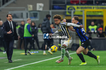 2024-02-04 - Weston McKennie of Juventus FC competes for the ball with Carlos Augusto of FC Internazionale during Serie A 2023/24 football match between FC Internazionale and Juventus FC at Giuseppe Meazza Stadium, Milan, Italy on February 04, 2024 - INTER - FC INTERNAZIONALE VS JUVENTUS FC - ITALIAN SERIE A - SOCCER