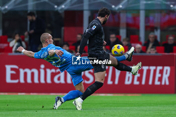 2024-02-11 - Leo Ostigard of SSC Napoli competes for the ball with Theo Hernandez of AC Milan during Serie A 2023/24 football match between AC Milan and SSC Napoli at San Siro Stadium, Milan, Italy on February 11, 2024 - AC MILAN VS SSC NAPOLI - ITALIAN SERIE A - SOCCER