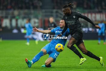 2024-02-11 - Rafael Leao of AC Milan competes for the ball with n13\during Serie A 2023/24 football match between AC Milan and SSC Napoli at San Siro Stadium, Milan, Italy on February 11, 2024 - AC MILAN VS SSC NAPOLI - ITALIAN SERIE A - SOCCER