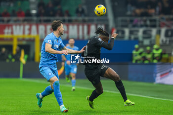 2024-02-11 - Rafael Leao of AC Milan competes for the ball with Amir Rrahmani of SSC Napoli during Serie A 2023/24 football match between AC Milan and SSC Napoli at San Siro Stadium, Milan, Italy on February 11, 2024 - AC MILAN VS SSC NAPOLI - ITALIAN SERIE A - SOCCER
