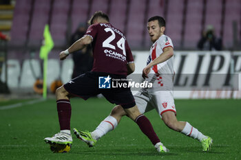 2024-02-24 - Salernitana's Argentinian defender Marco Pellegrino challenges for the ball with Monza’s Italian defender Samuele Birindelli during the Serie A football match between Unione Sportiva Salernitana vs Monza at the Arechi Stadium in Salerno on February 24, 2024. - US SALERNITANA VS AC MONZA - ITALIAN SERIE A - SOCCER
