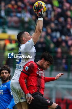 2024-03-10 - Elia Caprile of Empoli FC seen in action with Theo Hernandez of AC Milan during Serie A 2023/24 football match between AC Milan and Empoli FC at San Siro Stadium, Milan, Italy on March 10, 2024 - AC MILAN VS EMPOLI FC - ITALIAN SERIE A - SOCCER