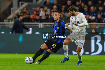 2024-04-01 - Lautaro Martinez of FC Internazionale competes for the ball with Bartosz Bereszynski of Empoli FC during Serie A 2023/24 football match between FC Internazionale and Empoli FC at Giuseppe Meazza Stadium, Milan, Italy on April 01, 2024 - INTER - FC INTERNAZIONALE VS EMPOLI FC - ITALIAN SERIE A - SOCCER