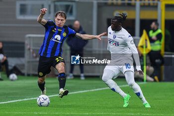 2024-04-01 - Nicolo Barella of FC Internazionale competes for the ball with M'Baye Niang of Empoli FC during Serie A 2023/24 football match between FC Internazionale and Empoli FC at Giuseppe Meazza Stadium, Milan, Italy on April 01, 2024 - INTER - FC INTERNAZIONALE VS EMPOLI FC - ITALIAN SERIE A - SOCCER