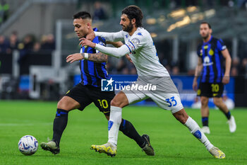2024-04-01 - Lautaro Martinez of FC Internazionale (L) competes for the ball with Sebastiano Luperto of Empoli FC (R) during Serie A 2023/24 football match between FC Internazionale and Empoli FC at Giuseppe Meazza Stadium, Milan, Italy on April 01, 2024 - INTER - FC INTERNAZIONALE VS EMPOLI FC - ITALIAN SERIE A - SOCCER