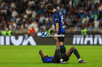 2024-04-14 - Marcus Thuram of FC Internazionale with Francesco Acerbi of FC Internazionale react at the end of the match during Serie A 2023/24 football match between FC Internazionale and Cagliari Calcio at Giuseppe Meazza Stadium, Milan, Italy on April 14, 2024 - INTER - FC INTERNAZIONALE VS CAGLIARI CALCIO - ITALIAN SERIE A - SOCCER
