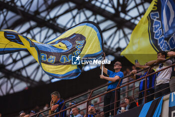 2024-04-14 - A fan waves a giant flag during Serie A 2023/24 football match between FC Internazionale and Cagliari Calcio at Giuseppe Meazza Stadium, Milan, Italy on April 14, 2024 - INTER - FC INTERNAZIONALE VS CAGLIARI CALCIO - ITALIAN SERIE A - SOCCER
