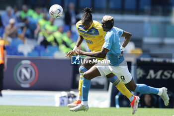 2024-04-14 - Frosinone's Nigerian defender Caleb Okoli challenges for the ball with SSC Napoli's Nigerian forward Victor Osimhen during the Serie A football match between SSC Napoli and Frosinone at the Diego Armando Maradona Stadium in Naples, southern Italy, on April 14, 2024. - SSC NAPOLI VS FROSINONE CALCIO - ITALIAN SERIE A - SOCCER