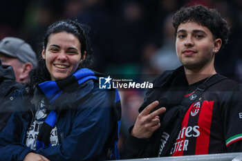 2024-04-22 - FC Internazionale and AC Milan supporters seen during Serie A 2023/24 football match between AC Milan and FC Internazionale at San Siro Stadium, Milan, Italy on April 22, 2024 - AC MILAN VS INTER - FC INTERNAZIONALE - ITALIAN SERIE A - SOCCER
