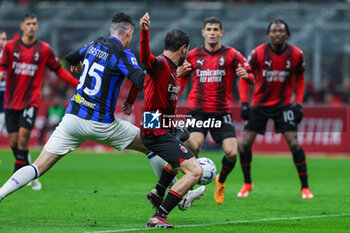 2024-04-22 - Davide Calabria of AC Milan competes for the ball with Alessandro Bastoni of FC Internazionale during Serie A 2023/24 football match between AC Milan and FC Internazionale at San Siro Stadium, Milan, Italy on April 22, 2024 - AC MILAN VS INTER - FC INTERNAZIONALE - ITALIAN SERIE A - SOCCER