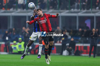 2024-04-22 - Matteo Gabbia of AC Milan competes for the ball with Marcus Thuram of FC Internazionale \during Serie A 2023/24 football match between AC Milan and FC Internazionale at San Siro Stadium, Milan, Italy on April 22, 2024 - AC MILAN VS INTER - FC INTERNAZIONALE - ITALIAN SERIE A - SOCCER