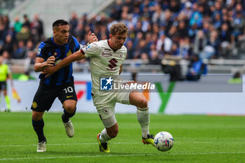 2024-04-28 - Lautaro Martinez of FC Internazionale competes for the ball with Matteo Lovato of Torino FC during Serie A 2023/24 football match between FC Internazionale and Torino FC at Giuseppe Meazza Stadium, Milan, Italy on April 28, 2024 - INTER - FC INTERNAZIONALE VS TORINO FC - ITALIAN SERIE A - SOCCER