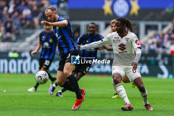 2024-04-28 - Carlos Augusto of FC Internazionale competes for the ball with Adrien Tameze of Torino FC during Serie A 2023/24 football match between FC Internazionale and Torino FC at Giuseppe Meazza Stadium, Milan, Italy on April 28, 2024 - INTER - FC INTERNAZIONALE VS TORINO FC - ITALIAN SERIE A - SOCCER