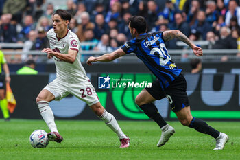 2024-04-28 - Samuele Ricci of Torino FC (L) seen in action with Hakan Calhanoglu of FC Internazionale (R) during Serie A 2023/24 football match between FC Internazionale and Torino FC at Giuseppe Meazza Stadium, Milan, Italy on April 28, 2024 - INTER - FC INTERNAZIONALE VS TORINO FC - ITALIAN SERIE A - SOCCER