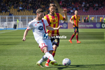 2024-04-27 - Geōrgios Kyriakopoulos of AC Monza in action against Remi Oudin of US Lecce - US LECCE VS AC MONZA - ITALIAN SERIE A - SOCCER