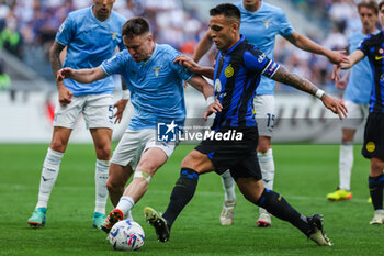 2024-05-19 - Lautaro Martinez of FC Internazionale competes for the ball with Patric Patricio Gabarron Gil of SS Lazio during Serie A 2023/24 football match between FC Internazionale and SS Lazio at Giuseppe Meazza Stadium, Milan, Italy on May 19, 2024 - INTER - FC INTERNAZIONALE VS SS LAZIO - ITALIAN SERIE A - SOCCER