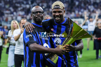 2024-05-19 - (L-R) Former France, Juventus and Barcelona defender Lilian Thuram celebrates with his son Marcus Thuram of FC Internazionale as FC Internazionale celebrates it's 20th league title following the Serie A 2023/24 football match between FC Internazionale and SS Lazio at Giuseppe Meazza Stadium, Milan, Italy on May 19, 2024 - INTER - FC INTERNAZIONALE VS SS LAZIO - ITALIAN SERIE A - SOCCER