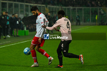 2024-02-02 - George Puscas (S.S.C. Bari) and Claudio Gomes (Palermo F.C.) during the Italian Serie BKT match between Palermo F.C. vs S.S.C. Bari on 1st February 2024 at the Renzo Barbera stadium in Palermo, Italy - PALERMO FC VS SSC BARI - ITALIAN SERIE B - SOCCER