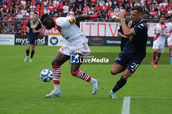 2024-10-06 - Davis Mensah of Mantova 1911 followed by Davide Adorni of Brescia Calcio FC during the Italian Serie B soccer championship football match between Mantova Calcio 1911 and Brescia Calcio FC at Danilo Martelli Stadium on October 6, 2024, Mantua, Italy. - MANTOVA 1911 VS BRESCIA CALCIO - ITALIAN SERIE B - SOCCER