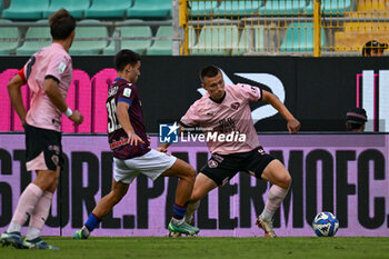 2024-10-26 - Kristoffer Lund Hansen (Palermo F.C.) in action against Antonio Vergara (A.C. Reggiana 1919) during the Italian Serie BKT match between Palermo F.C. vs A.C. Reggiana 1919 on 26th October 2024 at the Renzo Barbera stadium in Palermo, Italy - PALERMO FC VS AC REGGIANA - ITALIAN SERIE B - SOCCER