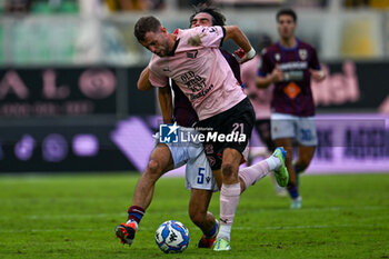 2024-10-26 - Jeremy Le Douaron (Palermo F.C.) in action against Alessandro Sersanti (A.C. Reggiana 1919) during the Italian Serie BKT match between Palermo F.C. vs A.C. Reggiana 1919 on 26th October 2024 at the Renzo Barbera stadium in Palermo, Italy - PALERMO FC VS AC REGGIANA - ITALIAN SERIE B - SOCCER