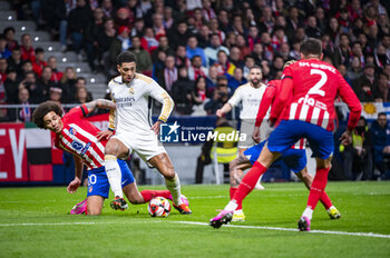 2024-01-18 - Jude Bellingham of Real Madrid seen in action with the ball against Axel Witsel of Atletico Madrid during the football match valid for the round of 16 of the Copa del Rey tournament between Atletico Madrid and Real Madrid played at Estadio Metropolitano in Madrid, Spain. - ATLETICO MADRID VS REAL MADRID - SPANISH CUP - SOCCER