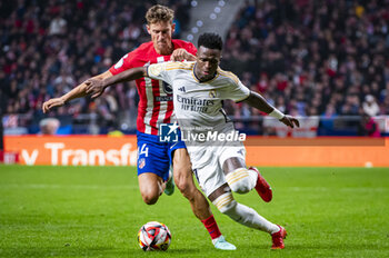 2024-01-18 - Vinicius Junior of Real Madrid seen in action with the ball against Marcos Llorente of Atletico Madrid during the football match valid for the round of 16 of the Copa del Rey tournament between Atletico Madrid and Real Madrid played at Estadio Metropolitano in Madrid, Spain. - ATLETICO MADRID VS REAL MADRID - SPANISH CUP - SOCCER