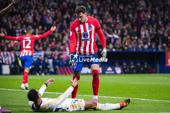 2024-01-18 - Jose Gimenez of Atletico Madrid seen helping Jude Bellingham of Real Madrid the football match valid for the round of 16 of the Copa del Rey tournament between Atletico Madrid and Real Madrid played at Estadio Metropolitano in Madrid, Spain. - ATLETICO MADRID VS REAL MADRID - SPANISH CUP - SOCCER