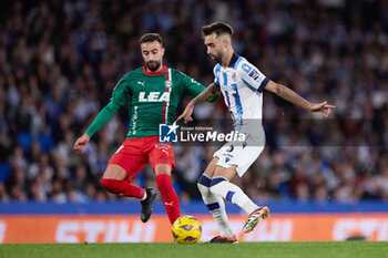 2024-01-02 - Brais Mendez of Real Sociedad competes for the ball with Abde Rebbach of Deportivo Alaves during the Spanish championship La Liga football match between Real Sociedad and Deportivo Alaves on January 2, 2024 at Reale Arena in San Sebastian, Spain - FOOTBALL - SPANISH CHAMP - REAL SOCIEDAD V ALAVES - SPANISH LA LIGA - SOCCER