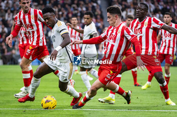 2024-01-21 - Vinicius Junior of Real Madrid seen in action against Dion Lopy and Sergio Arribas of Almeria during the La Liga EA Sports 23/24 football match between Real Madrid vs Almeria at Bernabeu stadium in Madrid, Spain. - REAL MADRID VS ALMERIA - SPANISH LA LIGA - SOCCER