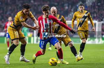 2024-01-31 - Rodrigo Riquelme (C) of Atletico Madrid seen in action against Alfonso Espino (L) and Isi Palazon of Rayo Vallecano during the La Liga EA Sports 2023/24 football match between Atletico Madrid vs Rayo Vallecano at Metropolitano stadium in Madrid, Spain. - ATLETICO MADRID VS RAYO VALLECANO - SPANISH LA LIGA - SOCCER