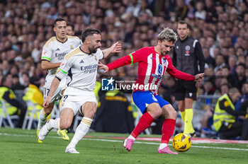 2024-02-04 - Antoine Griezmann of Atletico Madrid seen in action with the ball against Daniel Carvajal of Real Madrid during the La Liga EA Sports 2023/24 football match between Real Madrid vs Atletico Madrid at Santiago Bernabeu stadium in Madrid, Spain. - REAL MADRID VS ATLETICO MADRID - SPANISH LA LIGA - SOCCER