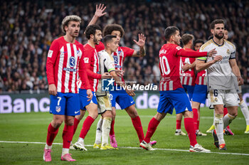 2024-02-04 - Lucas Vazquez of Real Madrid seen in action against Mario Hermoso and Axel Witsel of Atletico Madrid during the La Liga EA Sports 2023/24 football match between Real Madrid vs Atletico Madrid at Santiago Bernabeu stadium in Madrid, Spain. - REAL MADRID VS ATLETICO MADRID - SPANISH LA LIGA - SOCCER
