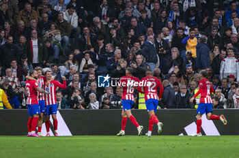 2024-02-04 - Marcos Llorente of Atletico Madrid seen celebrating his goal with Antoine Griezmann and Memphis Depay of Atletico Madrid during the La Liga EA Sports 2023/24 football match between Real Madrid vs Atletico Madrid at Santiago Bernabeu stadium in Madrid, Spain. - REAL MADRID VS ATLETICO MADRID - SPANISH LA LIGA - SOCCER