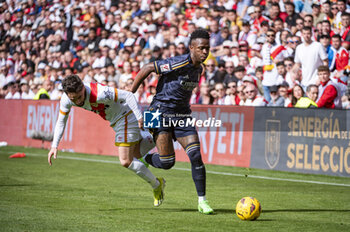 2024-02-18 - Vinicius Junior of Real Madrid (R) seen in action with the ball against Unai Lopez of Rayo Vallecano (L) during the La Liga EA Sports 2023/24 football match between Rayo Vallecano vs Real Madrid at Estadio Vallecas in Madrid, Spain. - RAYO VALLECANO VS REAL MADRID - SPANISH LA LIGA - SOCCER