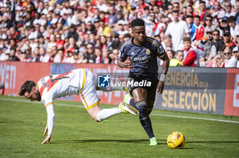 2024-02-18 - Vinicius Junior of Real Madrid (R) seen in action with the ball against Unai Lopez of Rayo Vallecano (L) during the La Liga EA Sports 2023/24 football match between Rayo Vallecano vs Real Madrid at Estadio Vallecas in Madrid, Spain. - RAYO VALLECANO VS REAL MADRID - SPANISH LA LIGA - SOCCER