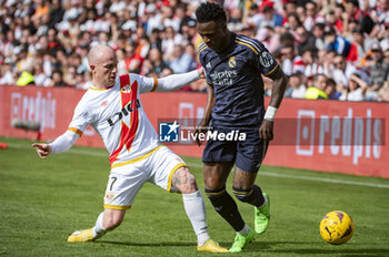 2024-02-18 - Vinicius Junior of Real Madrid (R) seen in action with the ball against Isi Palazon of Rayo Vallecano (L) during the La Liga EA Sports 2023/24 football match between Rayo Vallecano vs Real Madrid at Estadio Vallecas in Madrid, Spain. - RAYO VALLECANO VS REAL MADRID - SPANISH LA LIGA - SOCCER