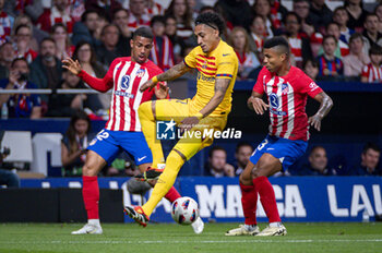 2024-03-17 - Raphael Dias Belloli (Raphinha) of FC Barcelona (C) seen in action with the ball against Samuel Lino (L) and Reinildo Mandava of Atletico Madrid (R) during the La Liga EA Sports 2023/24 football match between Atletico Madrid vs FC Barcelona at Civitas Metropolitano Stadium in Madrid, Spain. - ATLETICO MADRID VS FC BARCELONA - SPANISH LA LIGA - SOCCER